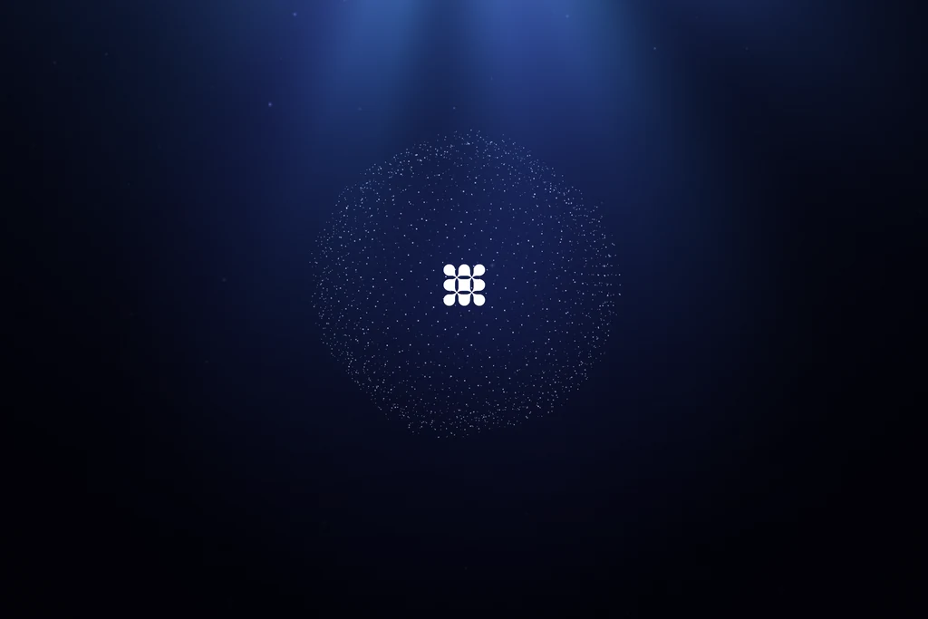 Launch film frame of a logo mark forming inside a sphere of particles