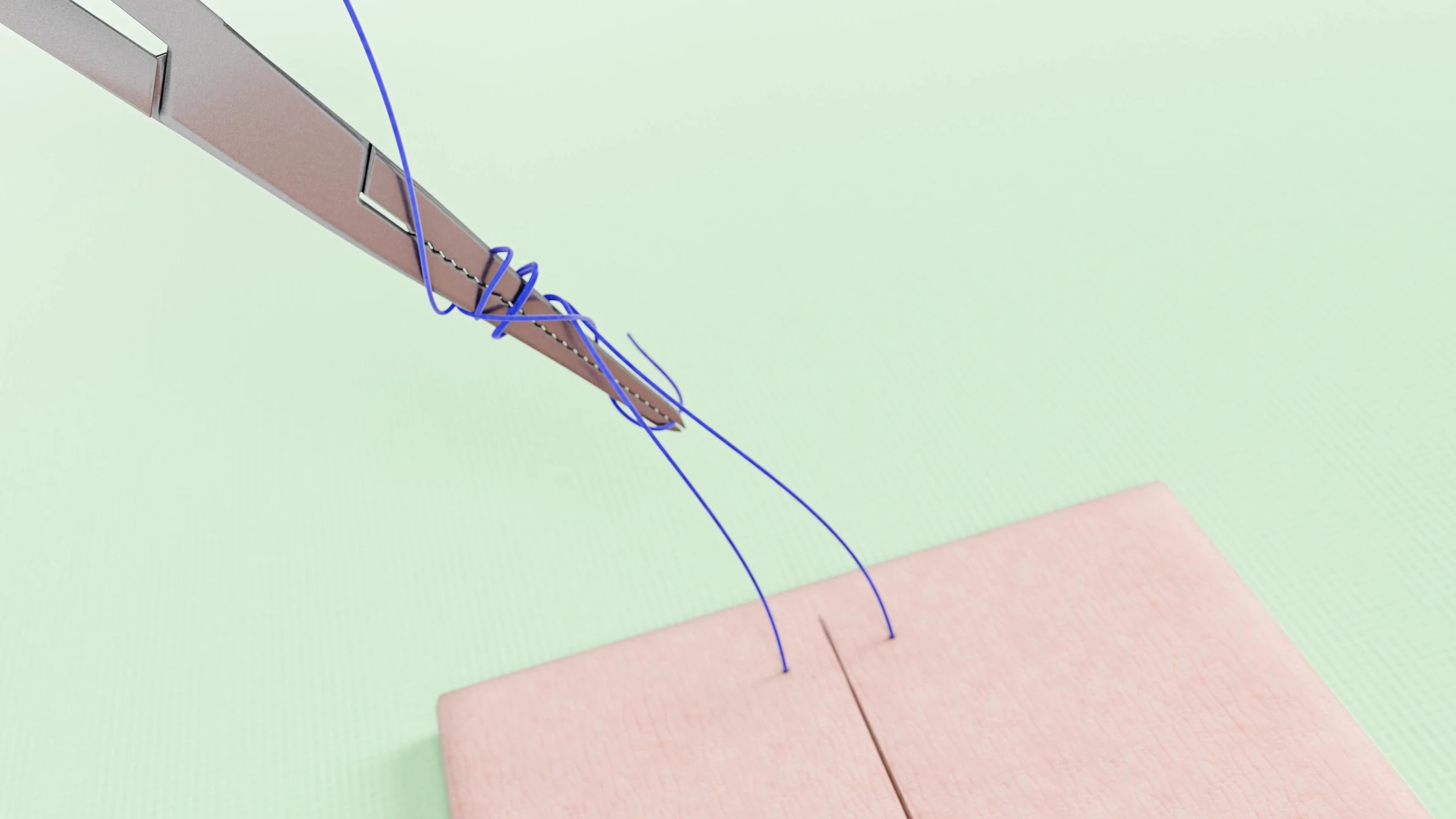 Needle driver with suture loops above the practice pad as the surface turns green