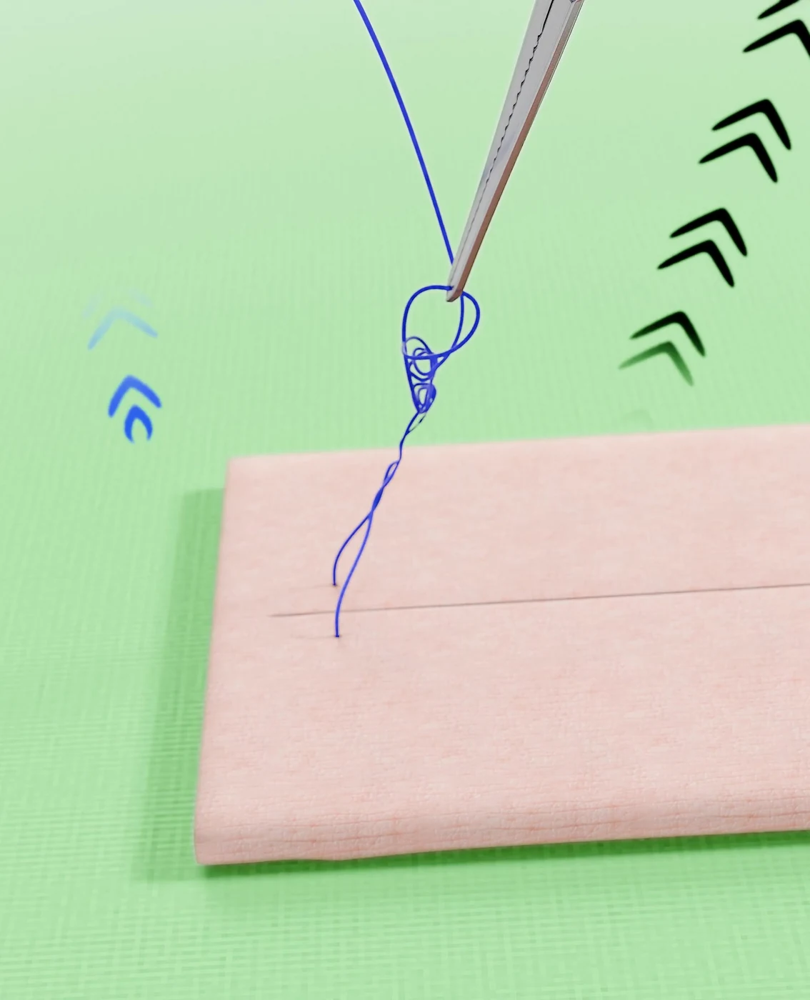 Sliding knot pushed down to an incision on a pink suture practice pad, on a green surface with direction arrows