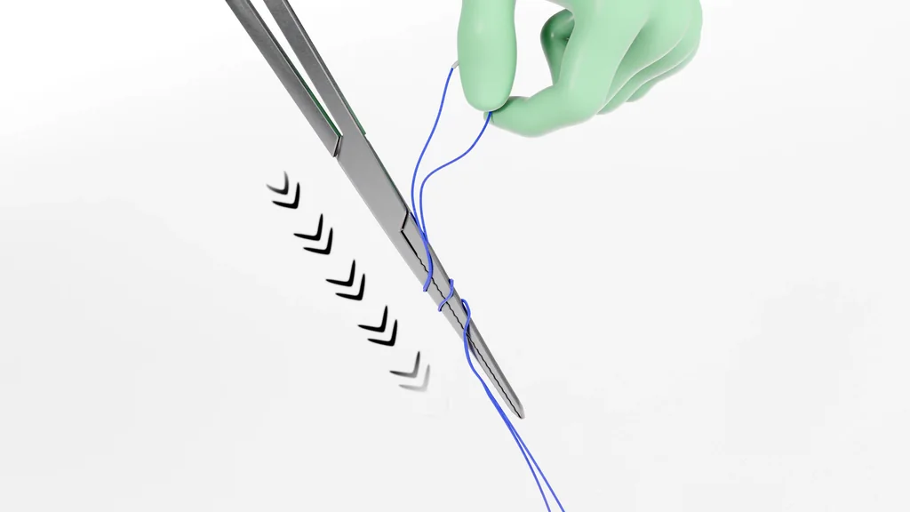 Training film still of a needle driver tying a sliding knot