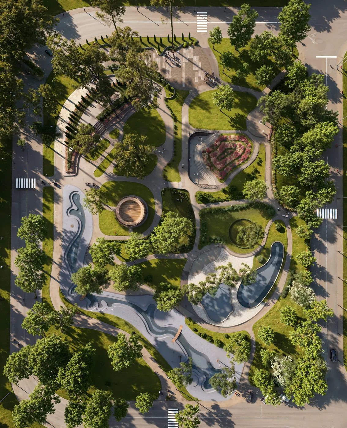 Portrait top-down render of a whole urban park with its water channel, pools, pavilion, amphitheatre and surrounding streets