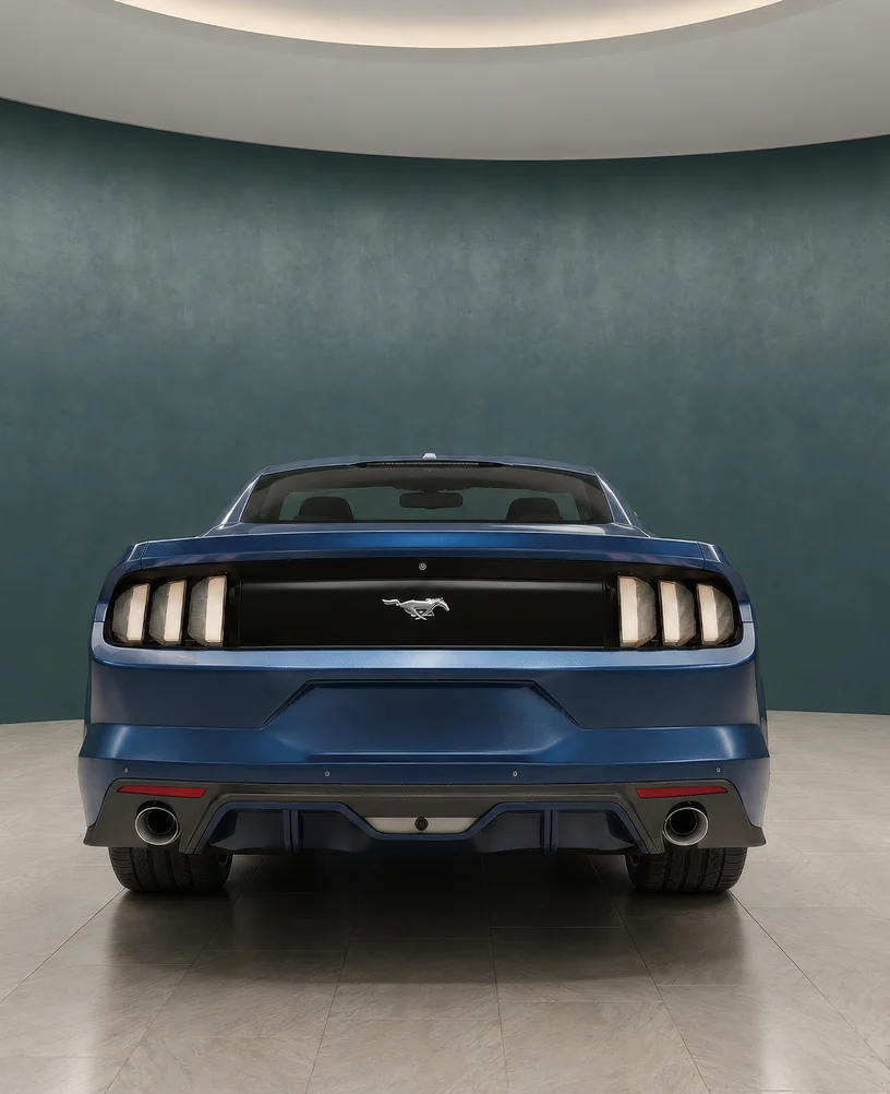 Rendering of a blue sports coupe seen from the rear in a virtual showroom with a teal curved wall