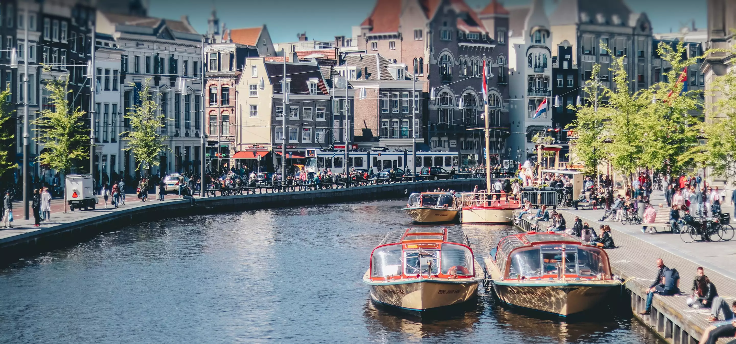 Amsterdam canal with boats and historic buildings, 3D visualization studios in the Netherlands