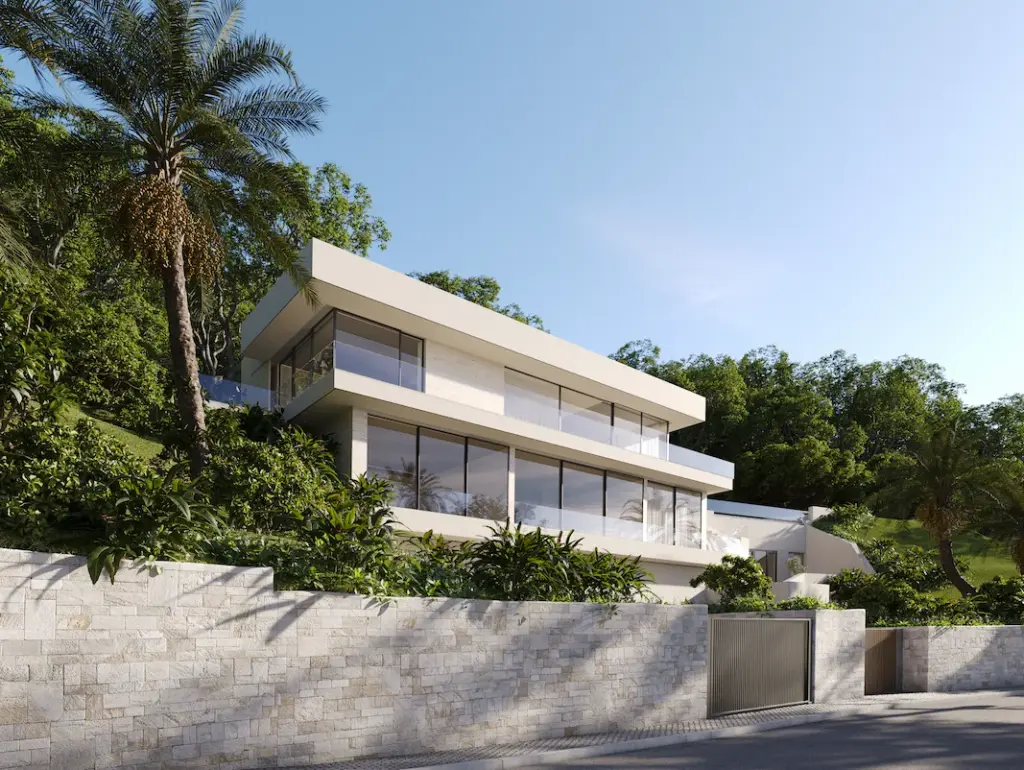 Minimalist modern villa exterior surrounded by lush greenery