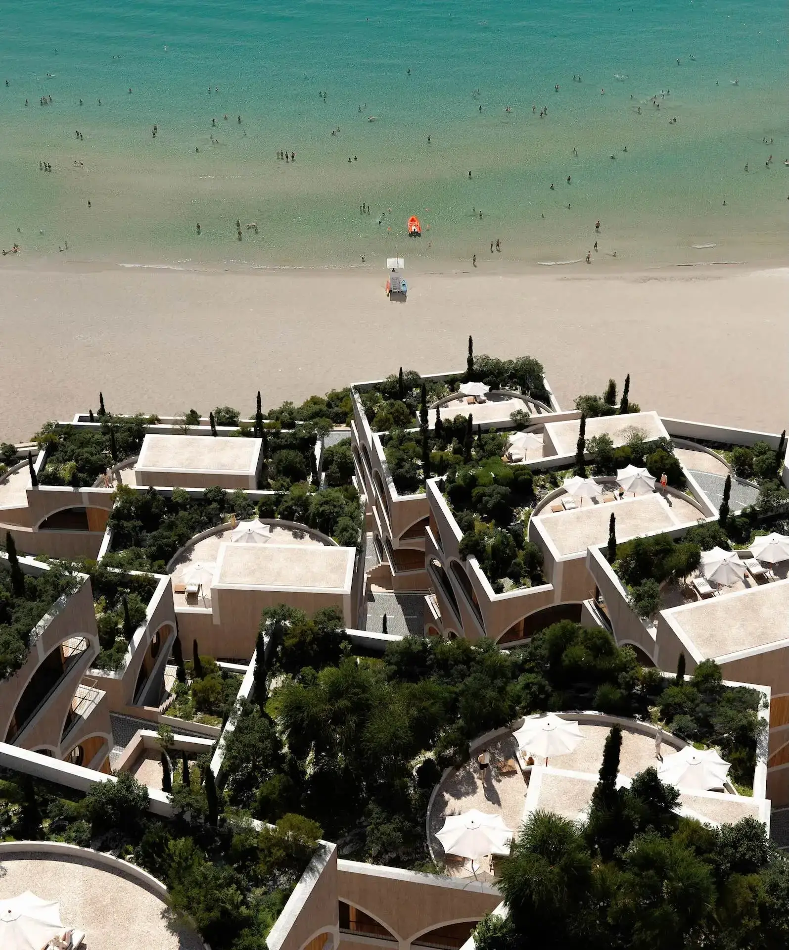 Coastal residential masterplan with terraced buildings overlooking the beach in a 3D architectural rendering portfolio