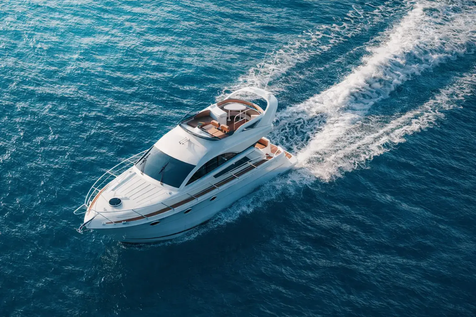 Sport motor yacht moving at speed across open sea leaving a defined wake