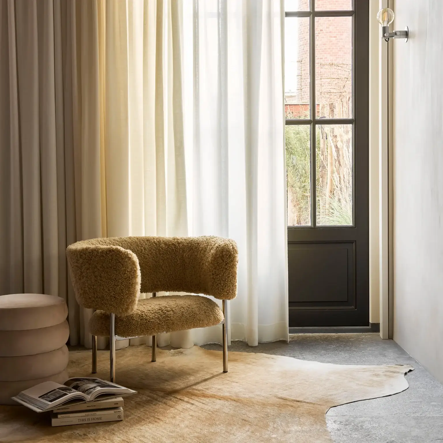 Upholstered lounge chair with textured fabric beside a window and sheer curtains, shown in a product visualization portfolio