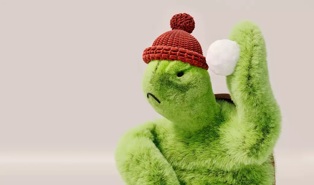 3D product render close up of green turtle plush wearing red knit hat holding white snowball