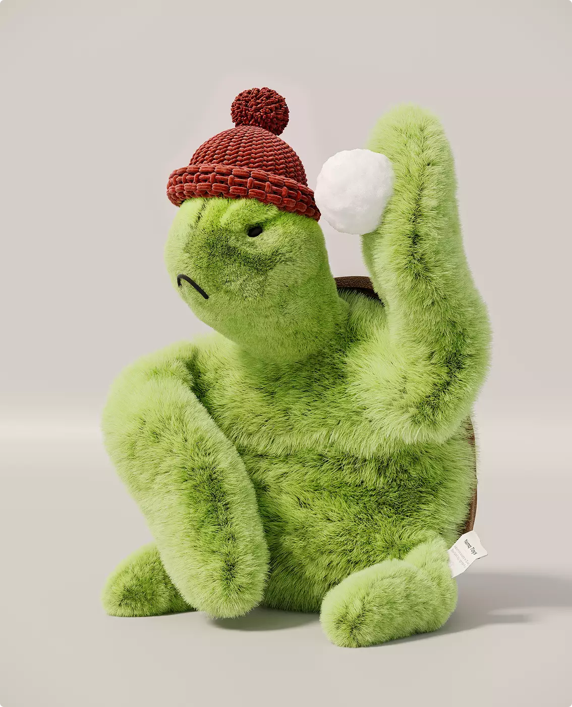 3D product render of green turtle plush wearing red knit hat holding white snowball