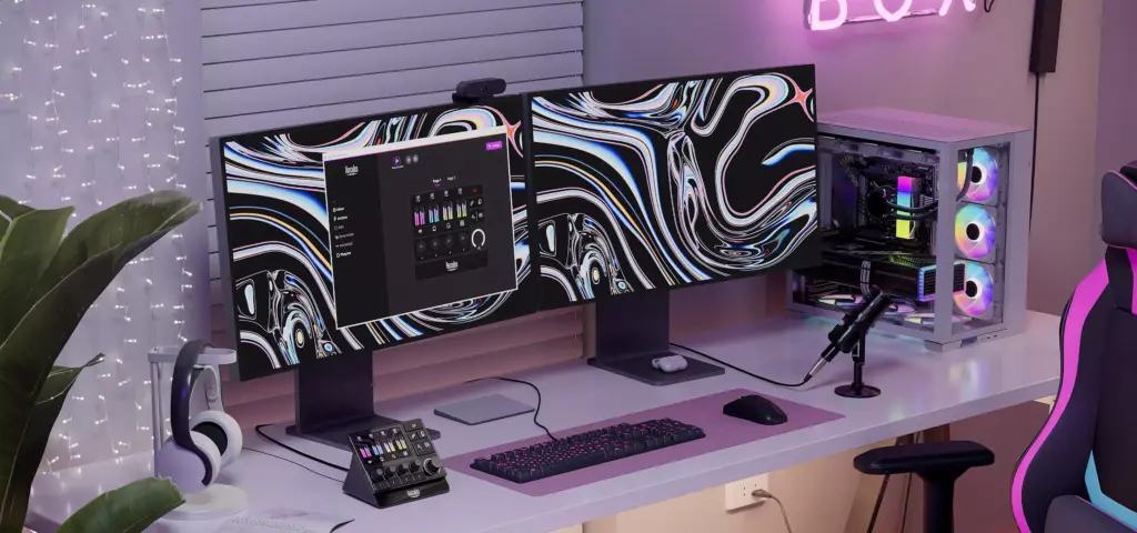 3D product rendering of a white gaming desk with dual monitors, RGB PC, mic, and pink accent chair
