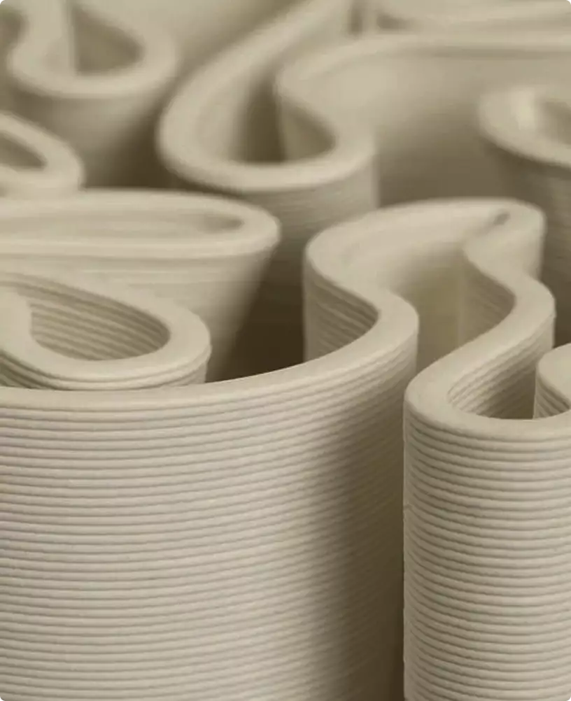 Close view of layered 3D printed ceramic walls forming organic channels and curves, material detail for 3D product renderings