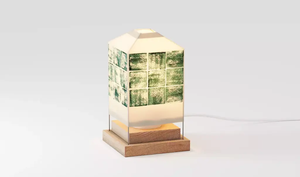 Modern geometric table lamp with green mosaic tile band and wooden base isolated on neutral background for 3D product visualization