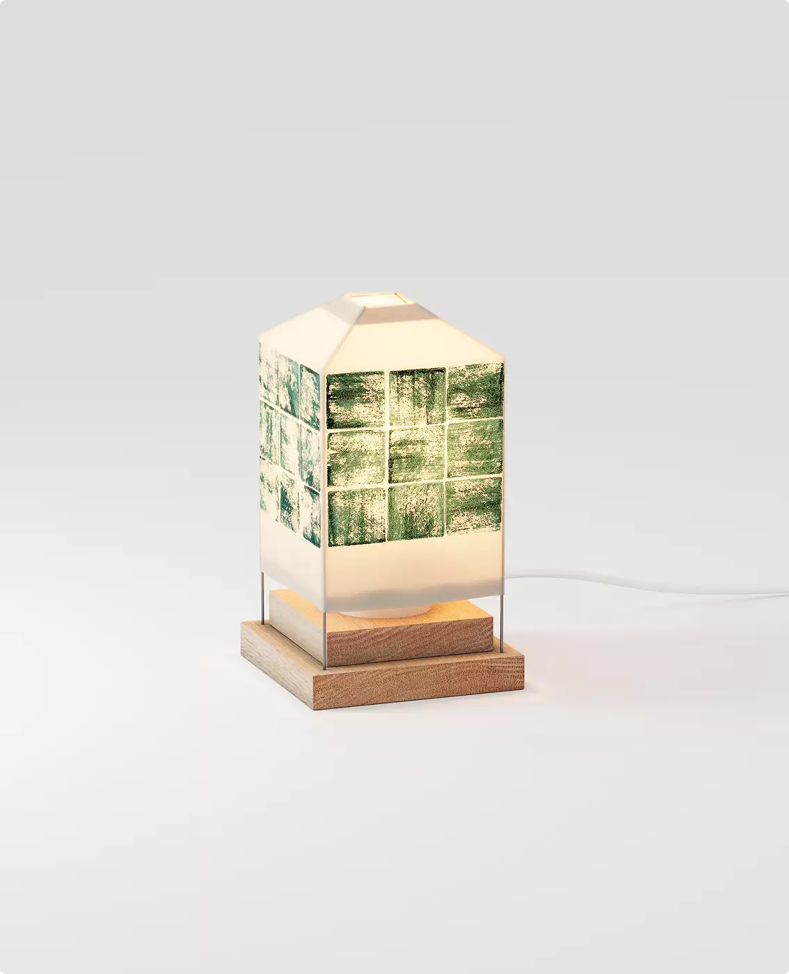 Geometric table lamp with green tile band and wooden base glowing on neutral background for 3D product visualization