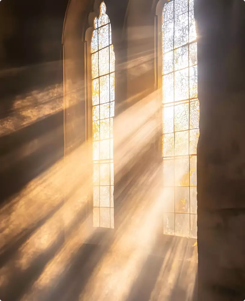 Sunlight rays streaming through tall stained glass windows inside arched interior for 3D product visualization
