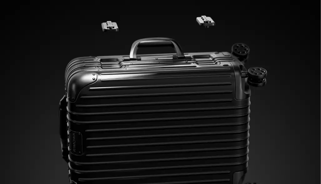 3D product visuals of a black suitcase with detached wheel components on a dark background