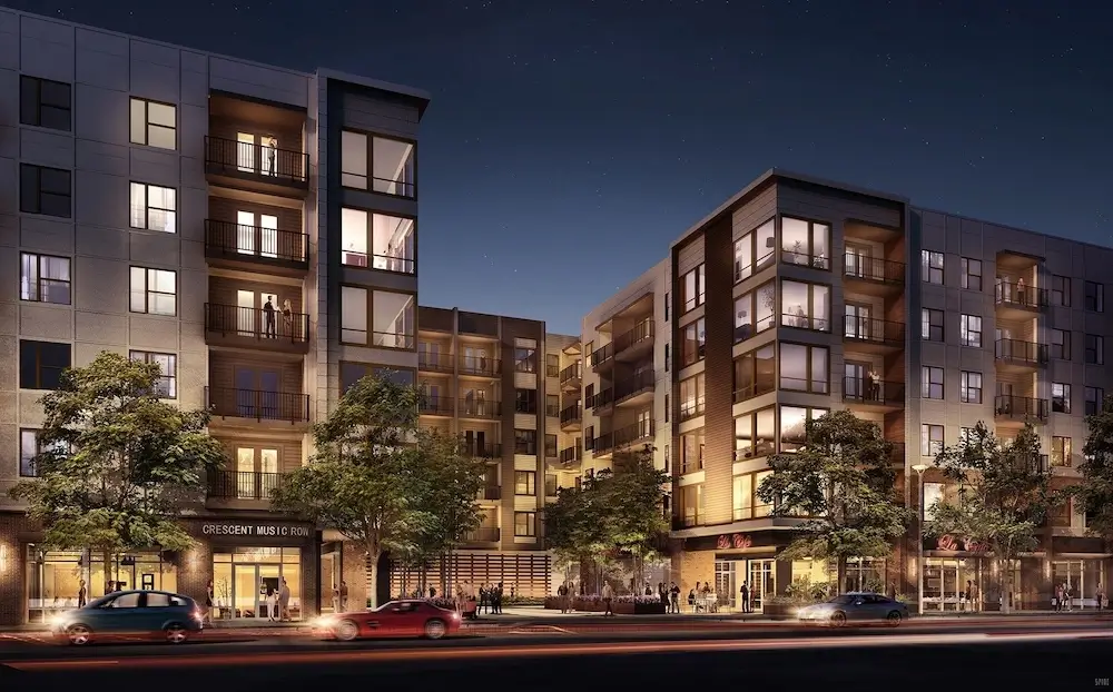 Architecture rendering services image of a residential housing development at night in an urban setting