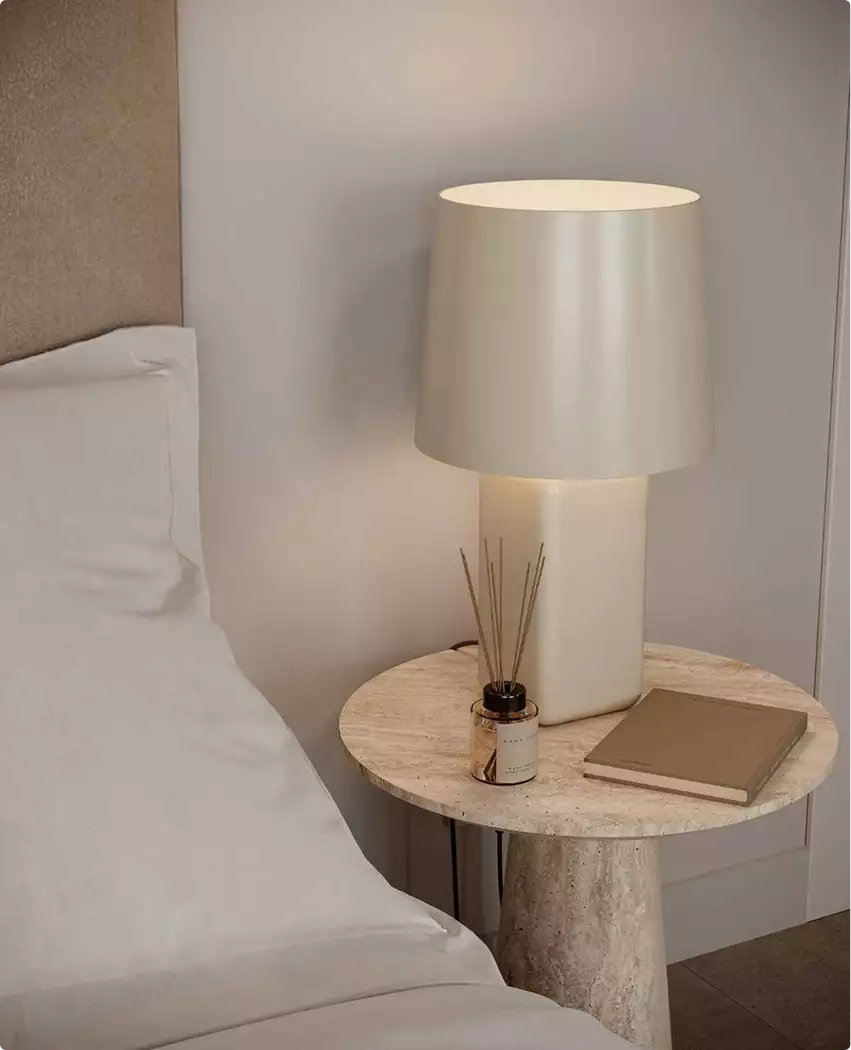 Bedside table with lamp, aerial residential community rendering, beside bed and neutral wall