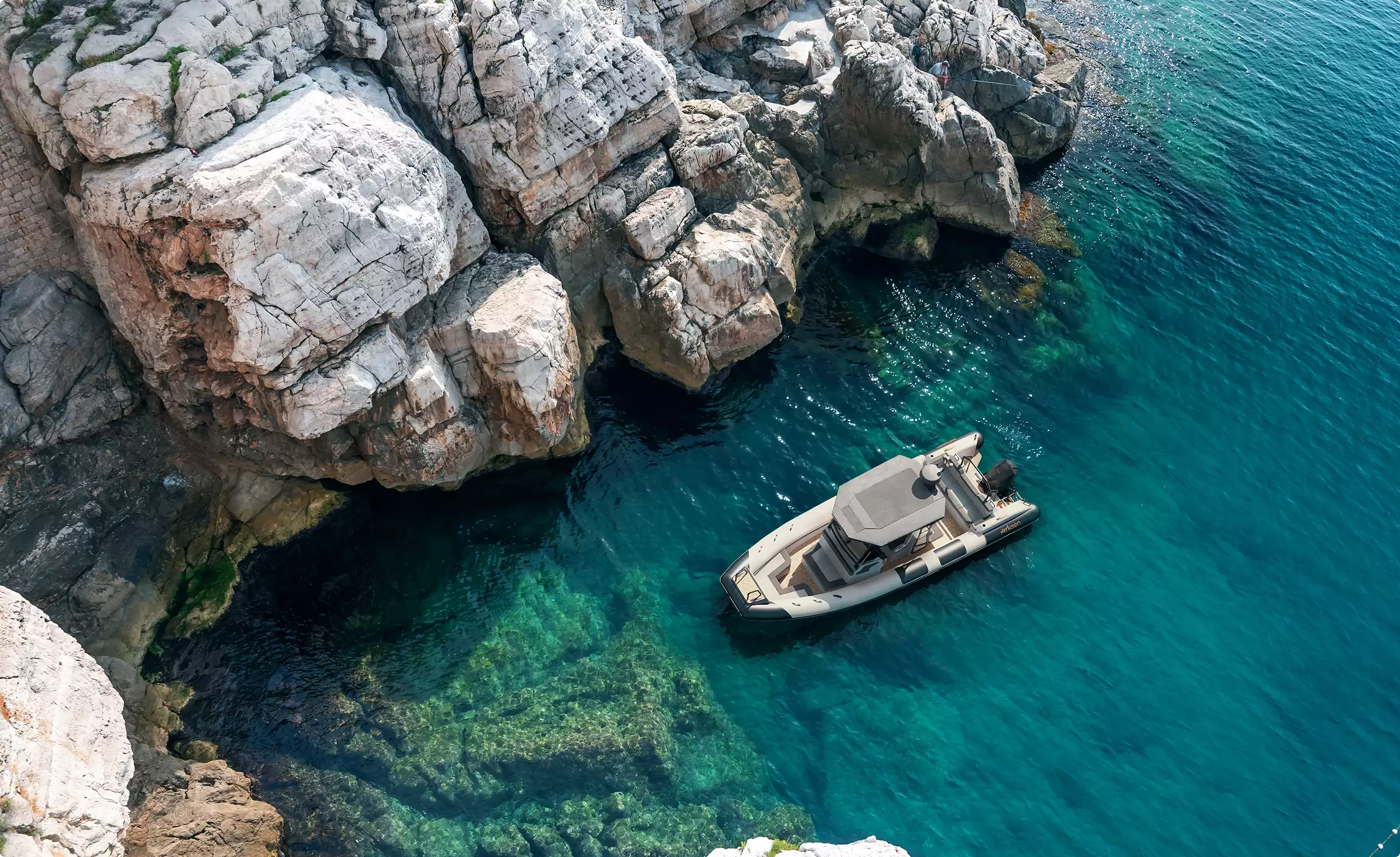 Boat rendering of a motorboat beside rocky cliffs in clear blue coastal water