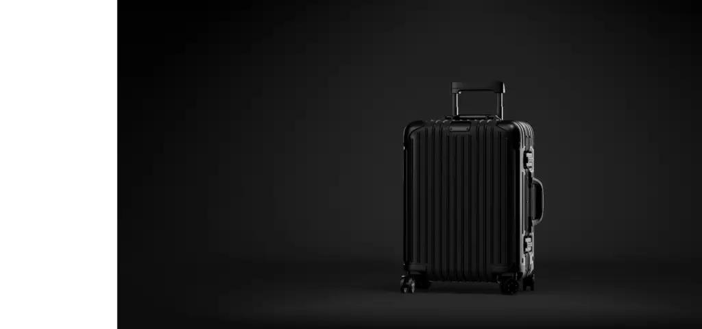 Cgi product animation of a black suitcase standing on wheels against a dark background