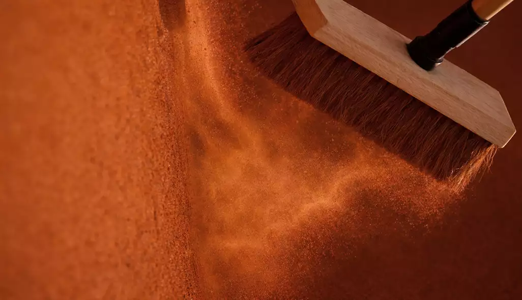 Clay tennis court design maintenance with wooden broom sweeping red dust particles