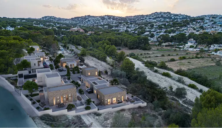 Aerial view of coastal villas at dusk, residential architectural renderings, amid hills and trees
