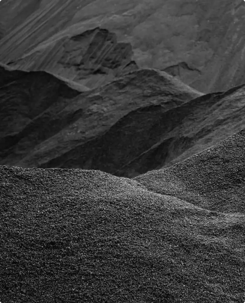 Black and white hills resembling piles of coffee grounds in atmospheric product design scene