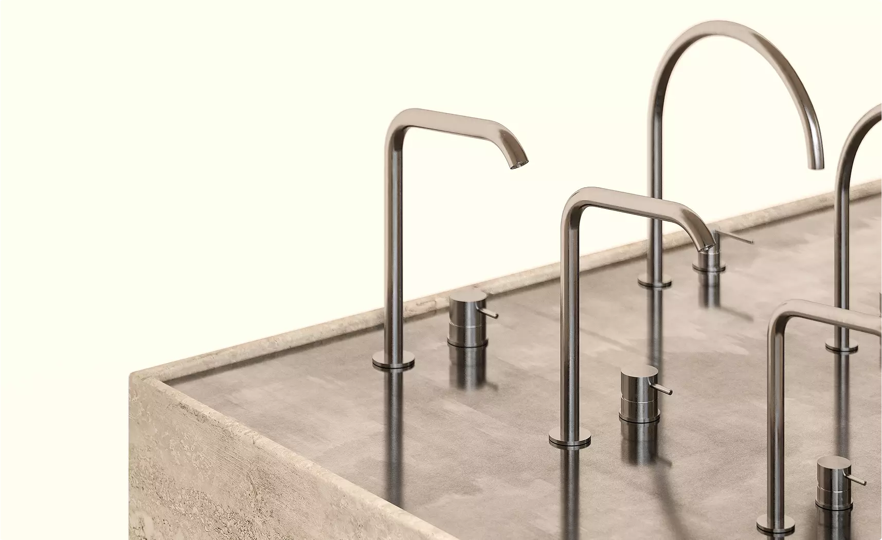 Faucet lineup in custom exhibition stand design on stone display counter with brushed metal finishes