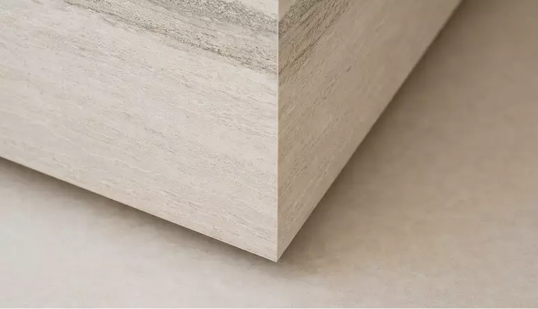 Plinth corner in custom exhibition stand design with light stone finish and clean geometric lines