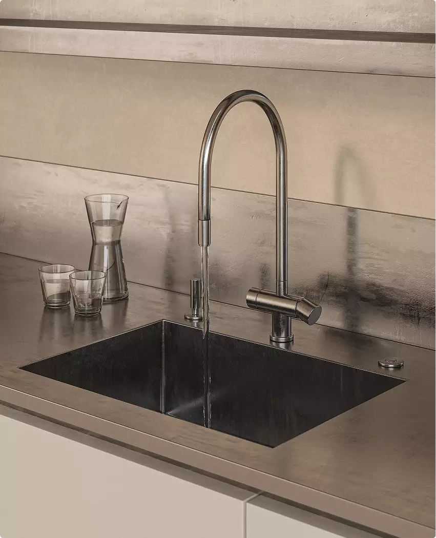 Modern sink display in custom exhibition stand design with brushed metal faucet and glasses