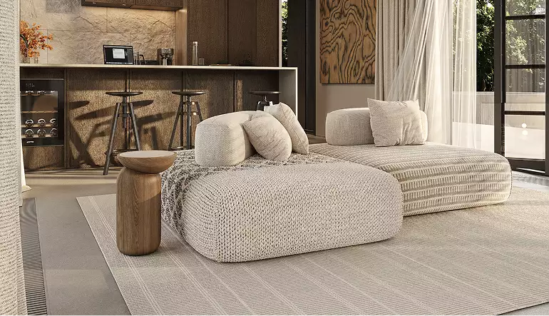 Interior modular homes living area with curved sofa, rug, bar stools, and open glass doors