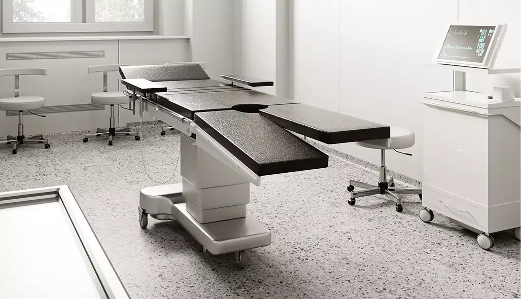 Medical center architectural rendering of an operating room with surgical table, monitor, and stools