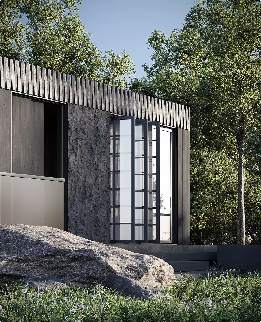 Modular home exterior design detail with folding glass doors, rock foreground, and dark facade