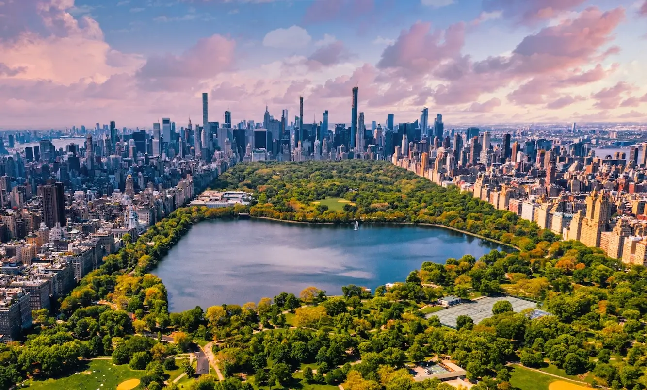 New York 3D architectural rendering of Central Park skyline with reservoir, towers, and sunset clouds