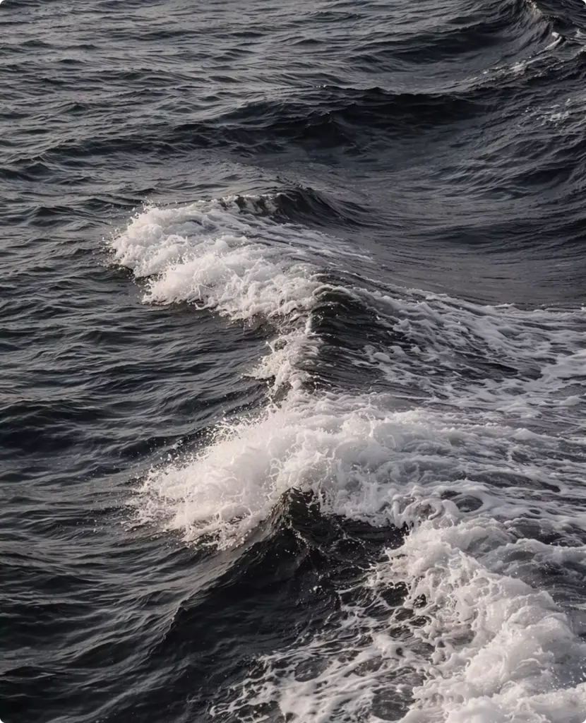 Churning ocean wake behind unseen yacht rendering with layered dark waves and foaming white crests