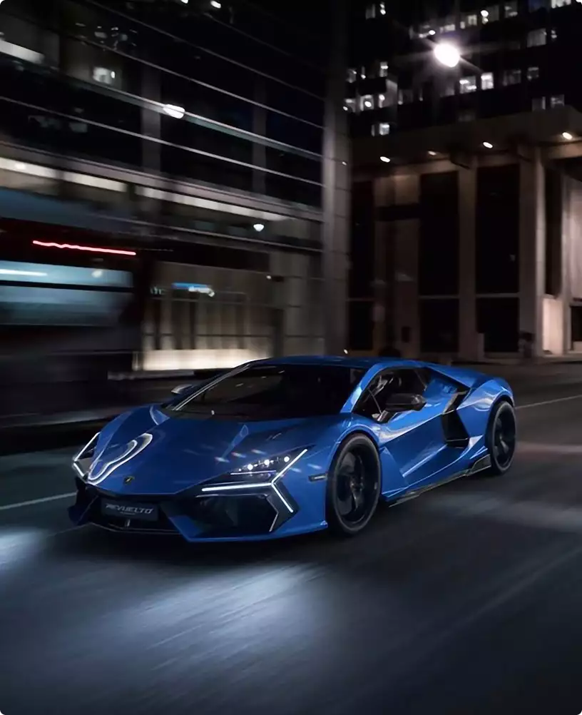 Office interior renderings featuring blue sports car driving through illuminated city street at night