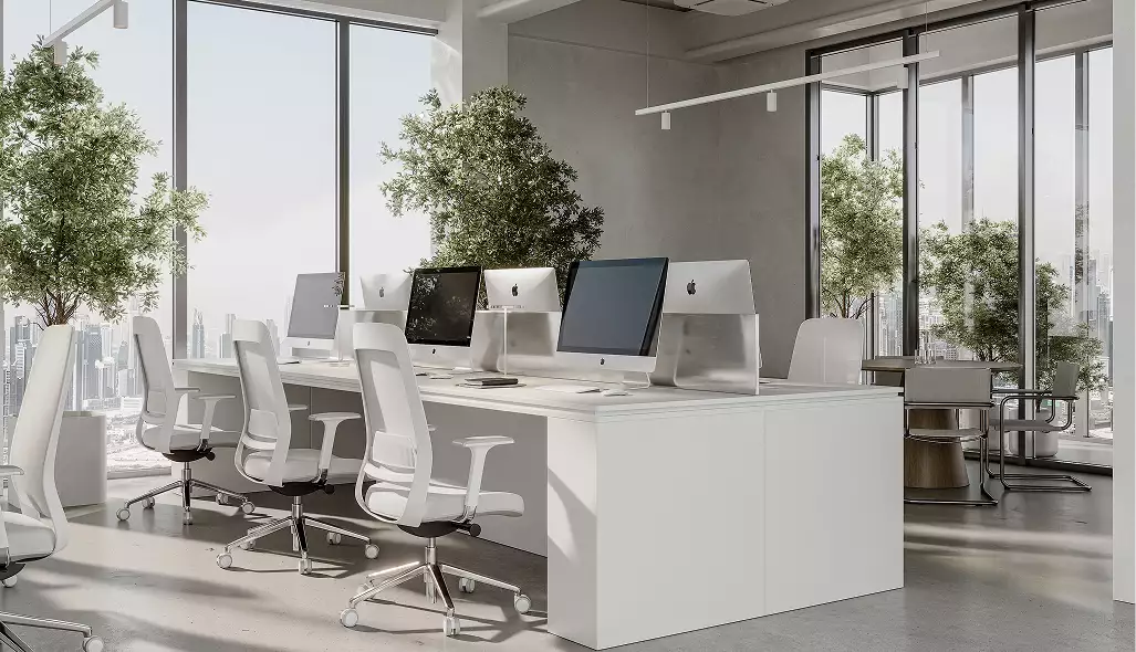 Office interior walkthrough of a bright open workspace with white desks, monitors, and city-view windows