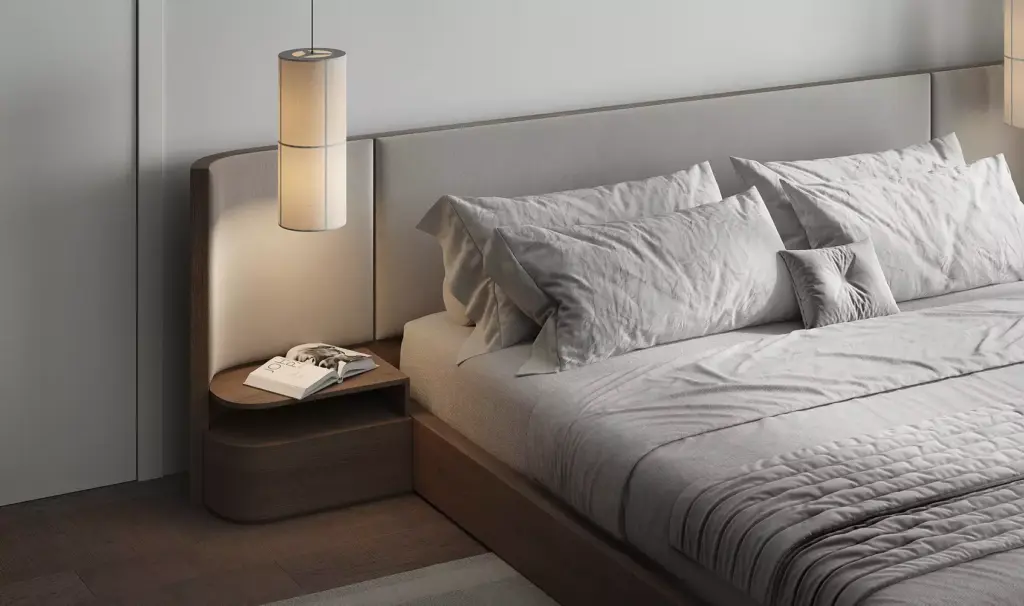 Residential complex design bedroom interior with upholstered bed, pendant lamp, and wooden bedside table