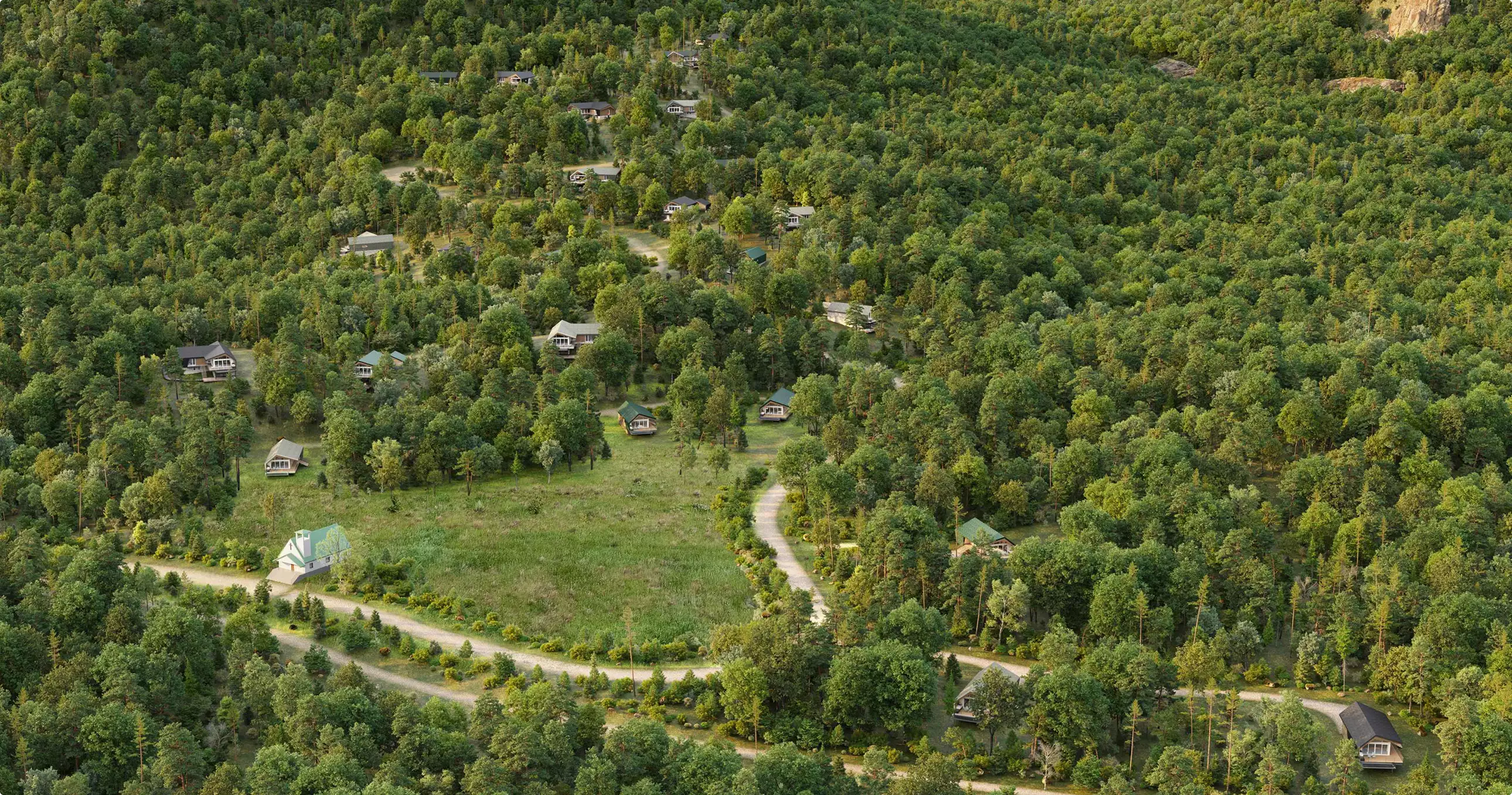 Retreat house design concept masterplan showing cabins, winding roads, and forested landscape from above