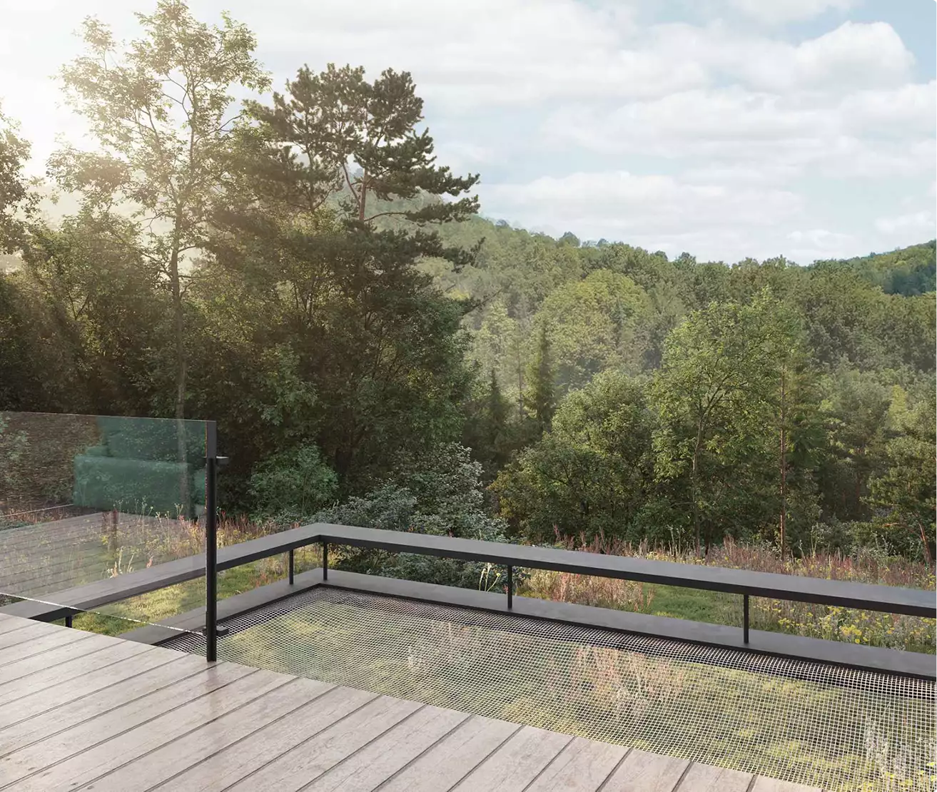 Retreat house design deck overlooking a forested valley with glass railing and open landscape view
