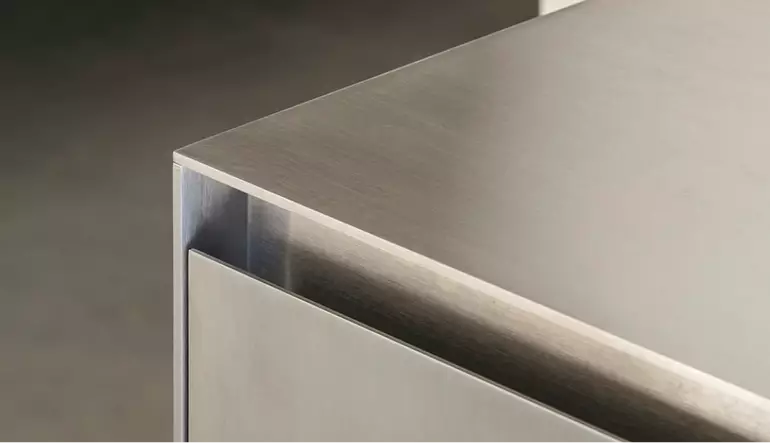 Metal cabinet corner in sales booth rendering with brushed steel top and clean panel lines
