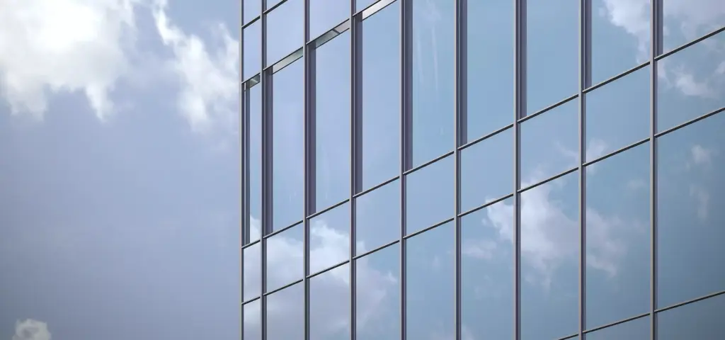 Close facade detail in skyscraper rendering with reflective glass panels and clouds mirrored in the windows.
