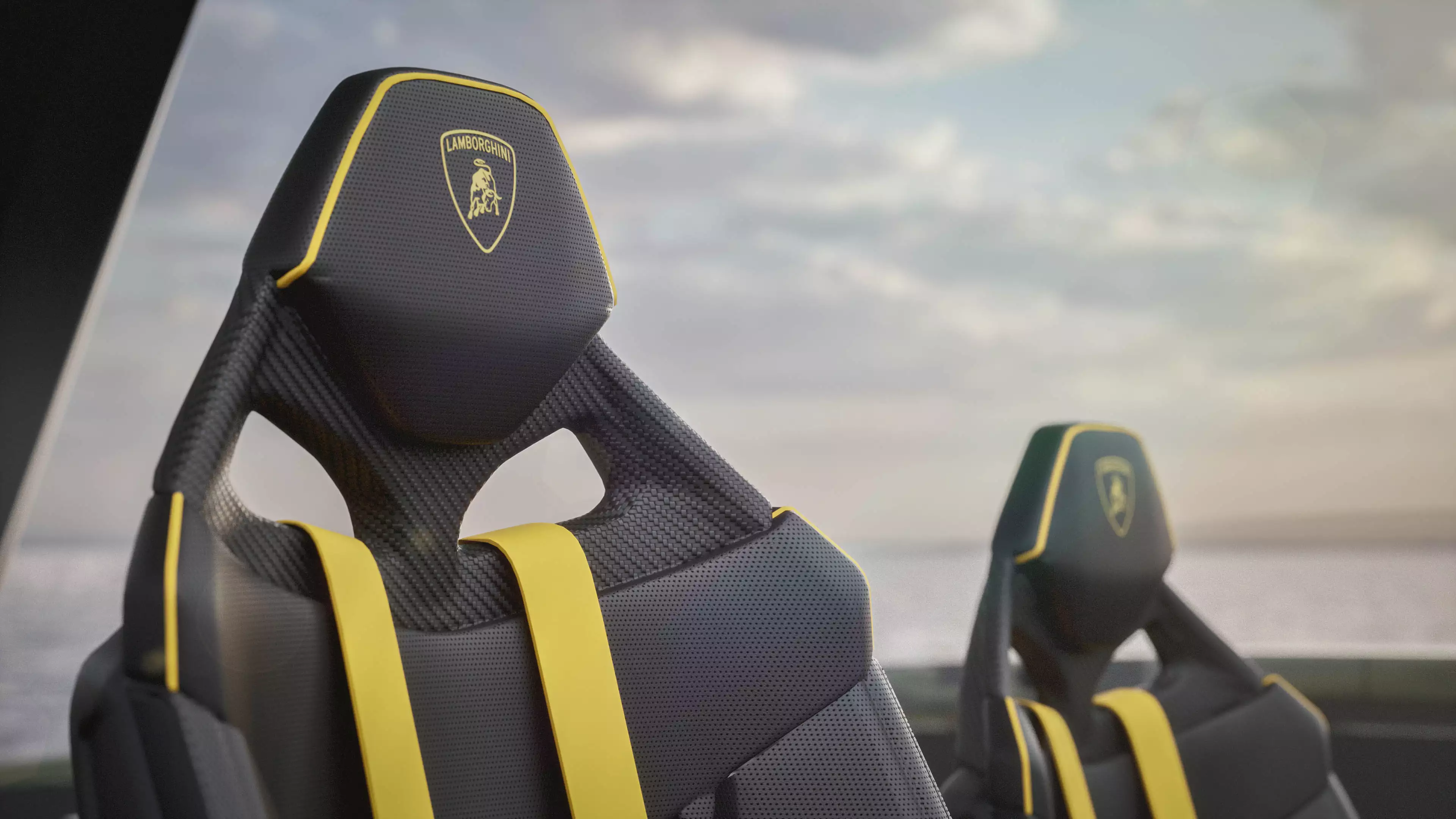 Yacht interior rendering with two Lamborghini-branded sport seats, yellow harness-style accents, and soft horizon backdrop in sleek yacht design