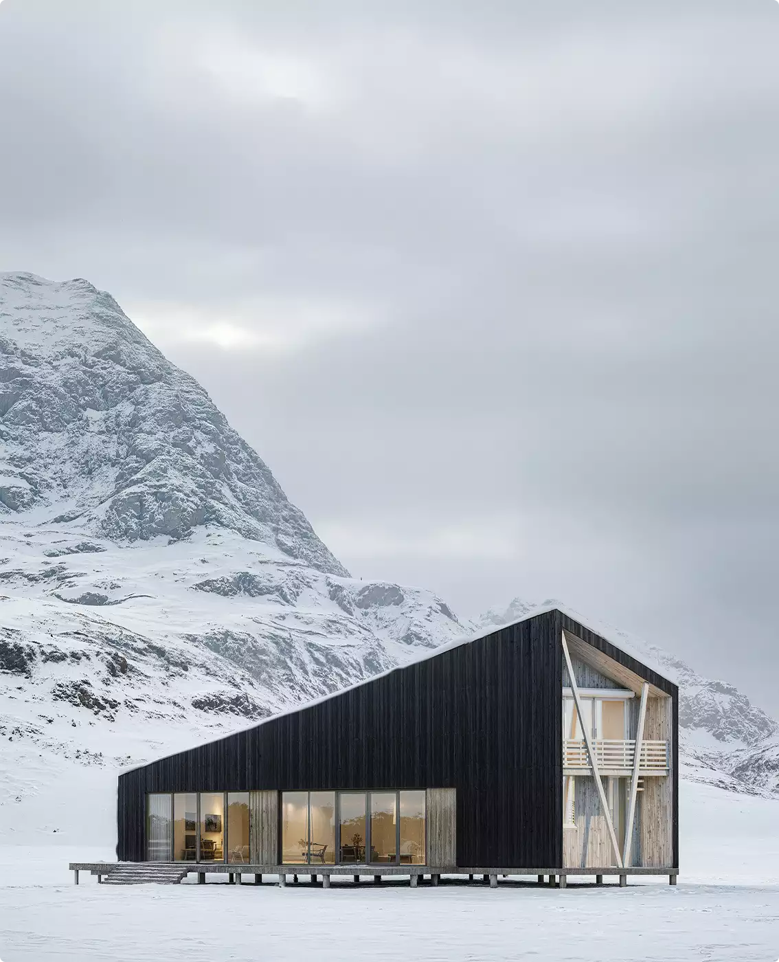 Winter exterior rendering of a modern black cabin with lit windows in a snowy mountain landscape