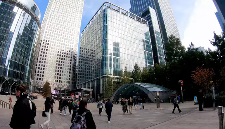 3D CGI fooh animations location at a city plaza, with glass towers, pedestrians, and a station entrance