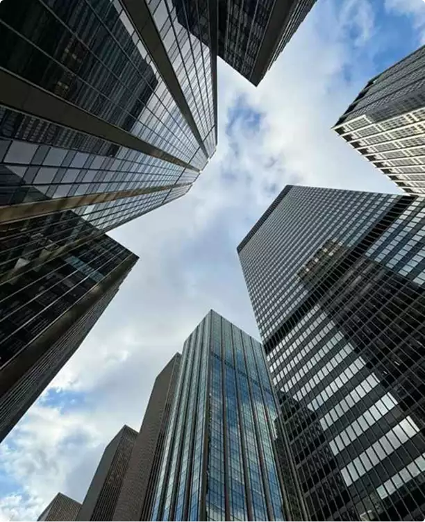 3D CGI fooh animations above a cluster of glass skyscrapers, viewed from street level toward the sky