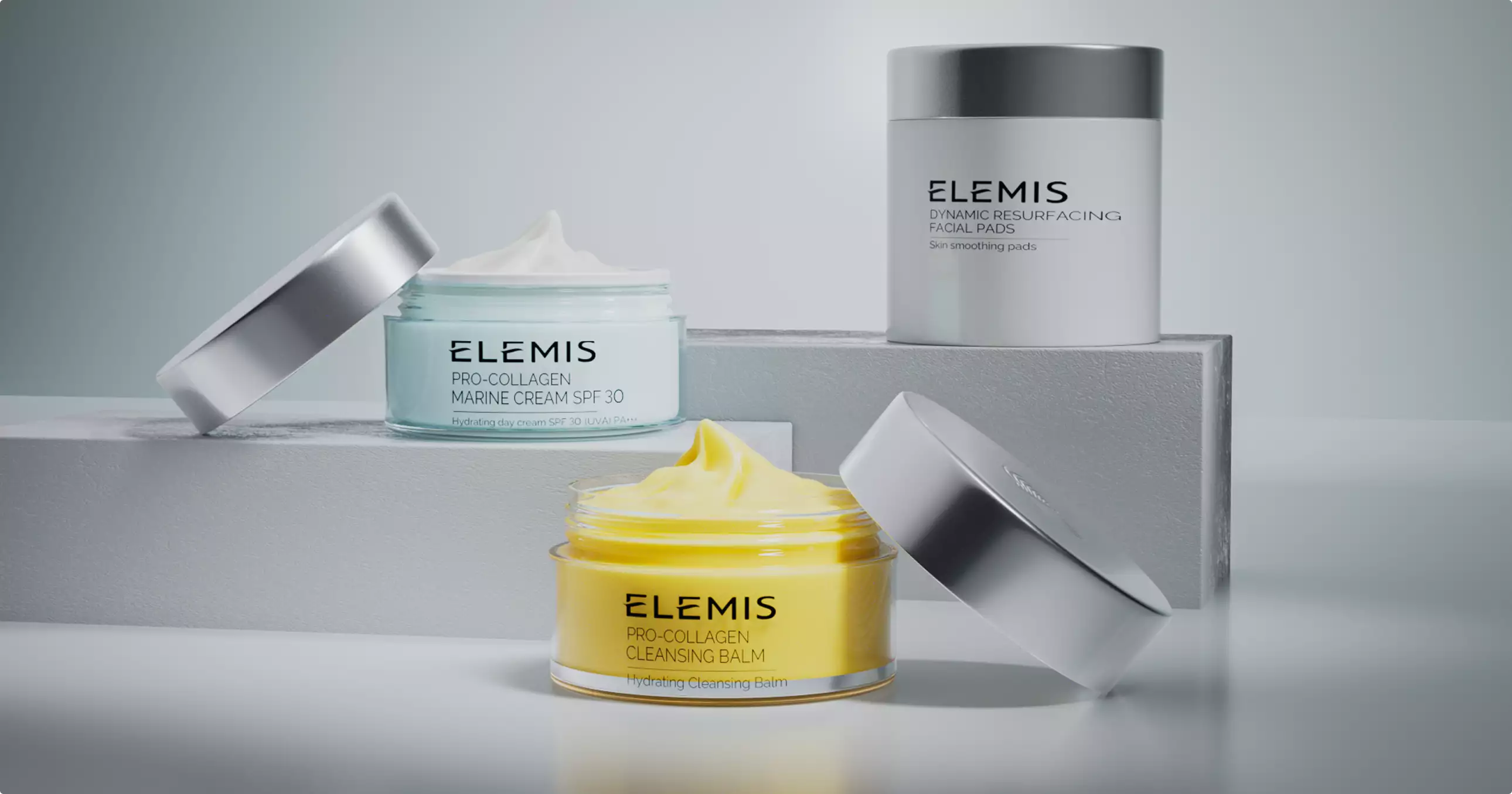 3d cosmetic skincare jars with cream textures on white blocks in clean minimal studio setup