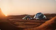 3D exterior visualization services for a futuristic desert building set among dunes at sunset