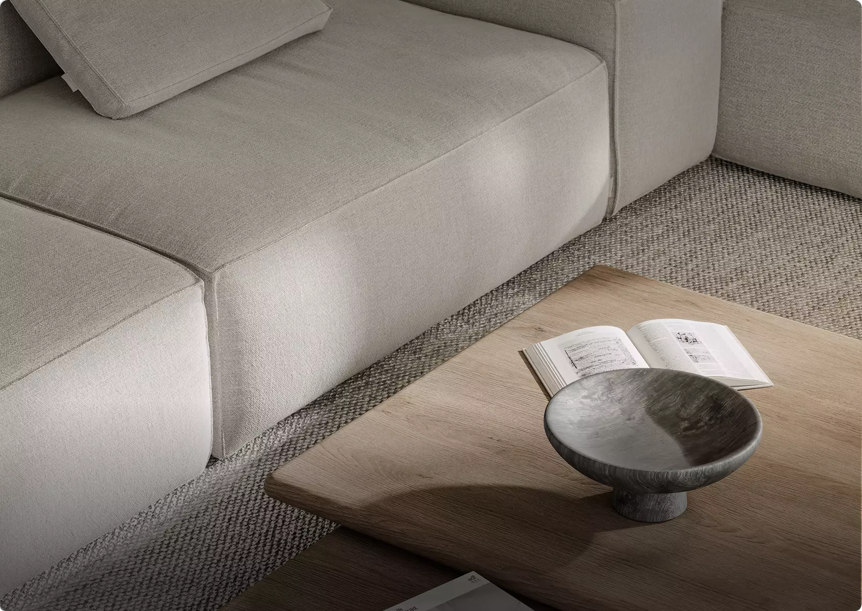 Close view of fabric sofa and wooden coffee table with book and bowl, textured rug, 3d furniture rendering