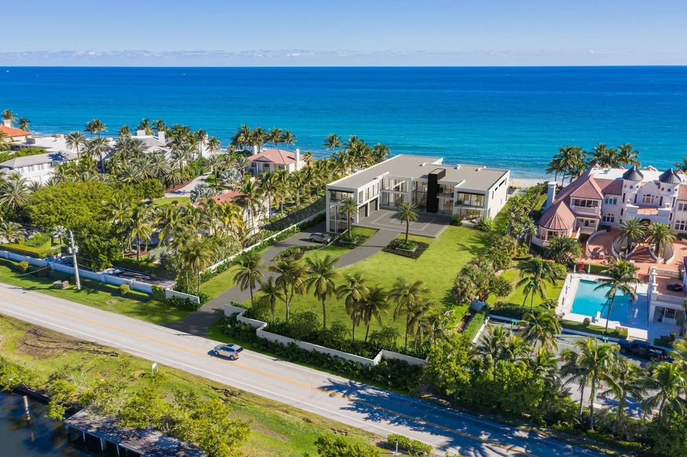 Waterfront mansion 3D rendering Miami aerial view with ocean, palm trees, and luxury estate