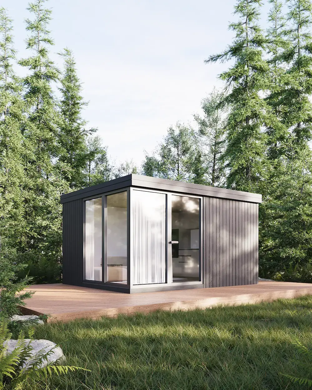 Compact modular home with full-height glass and dark cladding in a forest setting